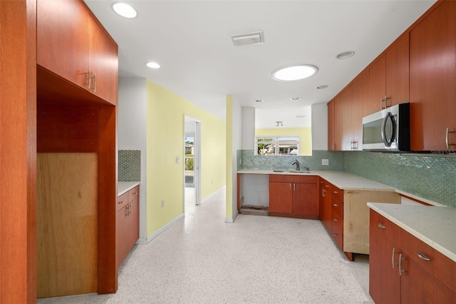 3932 Shore Acres Blvd NE, Saint Petersburg, FL 33703 - kitchen with a sink, tasteful backsplash, stainless steel microwave, light countertops, and recessed lighting