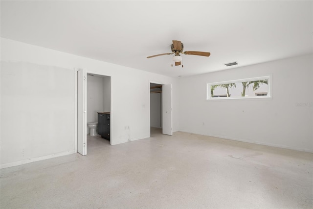 3932 Shore Acres Blvd NE, Saint Petersburg, FL 33703 - unfurnished bedroom with dark speckled floor, ensuite bath, baseboards, and a ceiling fan