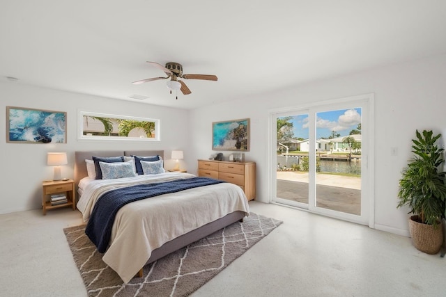 3932 Shore Acres Blvd NE, Saint Petersburg, FL 33703 - bedroom with access to exterior, a water view, ceiling fan, and light carpet