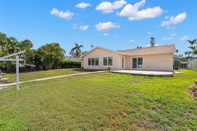 3932 Shore Acres Blvd NE, Saint Petersburg, FL 33703 - back of house featuring a patio, a yard, and stucco siding