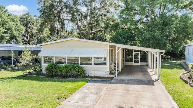 3542 Castle Dr, Zephyrhills, FL 33540 - manufactured / mobile home featuring a front yard, a carport, and driveway