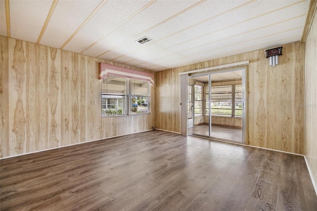3542 Castle Dr, Zephyrhills, FL 33540 - spare room featuring wooden walls and wood finished floors