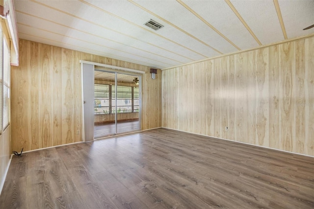 3542 Castle Dr, Zephyrhills, FL 33540 - empty room featuring wooden walls and wood finished floors