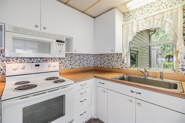 3542 Castle Dr, Zephyrhills, FL 33540 - kitchen with white appliances, a sink, white cabinetry, and butcher block counters