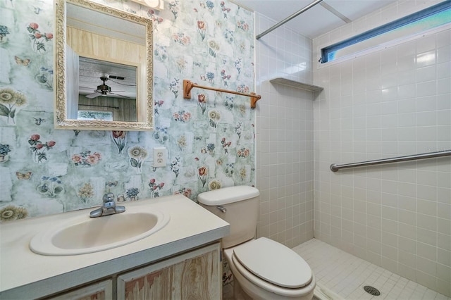 3542 Castle Dr, Zephyrhills, FL 33540 - full bathroom with wallpapered walls, tiled shower, vanity, toilet, and a ceiling fan