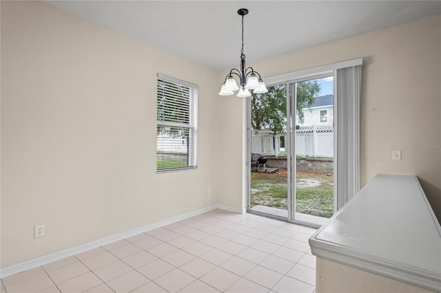 7249 Bridgeview Dr, Wesley Chapel, FL 33545 - unfurnished dining area featuring a chandelier, plenty of natural light, and light tile patterned flooring