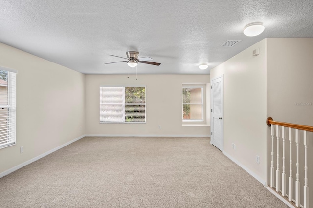 7249 Bridgeview Dr, Wesley Chapel, FL 33545 - carpeted spare room featuring ceiling fan and a textured ceiling