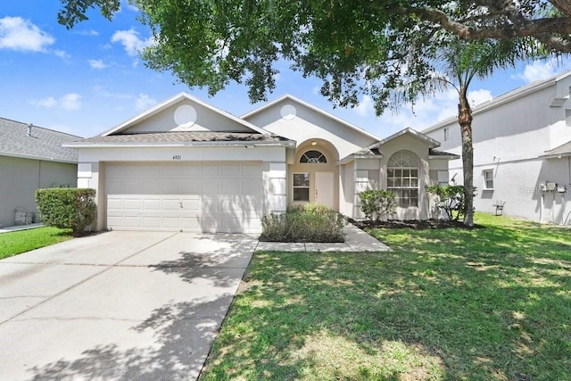4921 Wessex Way, Land O Lakes, FL 34638 - single story home featuring a garage, driveway, a front lawn, and stucco siding