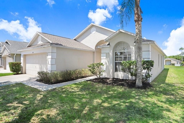 4921 Wessex Way, Land O Lakes, FL 34638 - view of front of house featuring a garage, a front yard, stucco siding, and driveway