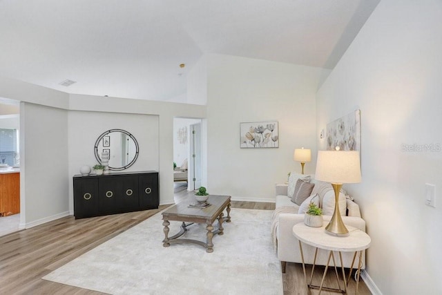 4921 Wessex Way, Land O Lakes, FL 34638 - living area with wood finished floors, baseboards, and high vaulted ceiling