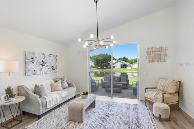 4921 Wessex Way, Land O Lakes, FL 34638 - living area with lofted ceiling, wood finished floors, a chandelier, a water view, and baseboards
