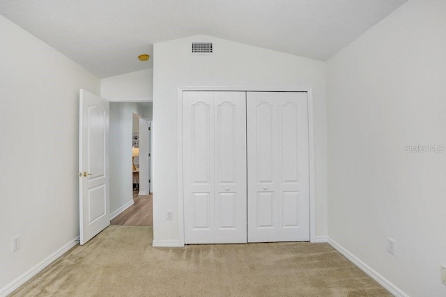 4921 Wessex Way, Land O Lakes, FL 34638 - unfurnished bedroom featuring lofted ceiling, light carpet, baseboards, and a closet