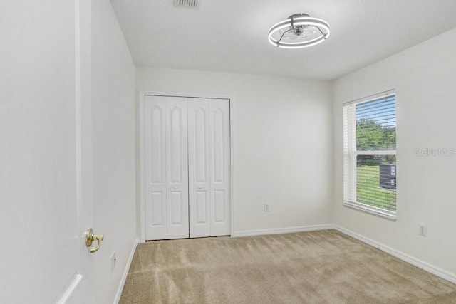 4921 Wessex Way, Land O Lakes, FL 34638 - unfurnished bedroom featuring baseboards, carpet, and a closet