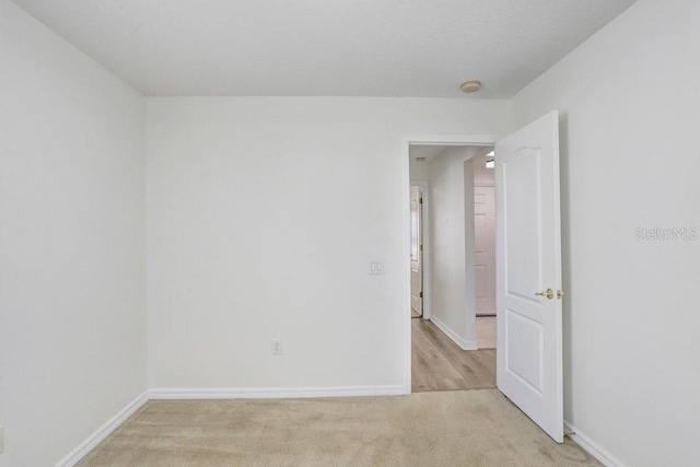 4921 Wessex Way, Land O Lakes, FL 34638 - empty room with baseboards, light carpet, and a smoke detector