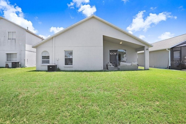 4921 Wessex Way, Land O Lakes, FL 34638 - back of property with central AC unit, a lawn, outdoor lounge area, and stucco siding