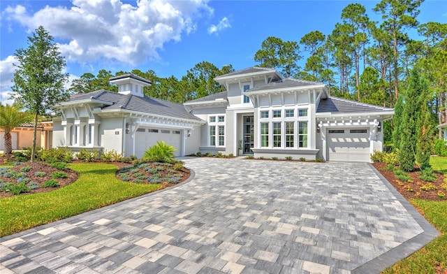 256 Stirling Bridge Dr, Ormond Beach, FL 32174 - view of front of property with an attached garage, decorative driveway, stucco siding, and a tiled roof