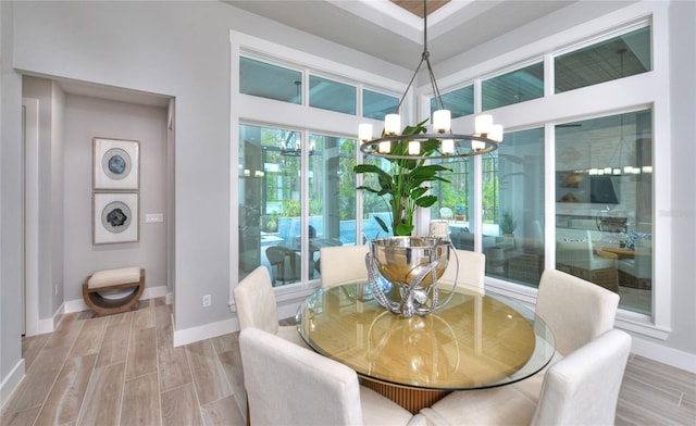 256 Stirling Bridge Dr, Ormond Beach, FL 32174 - dining area with a chandelier, baseboards, and wood finished floors