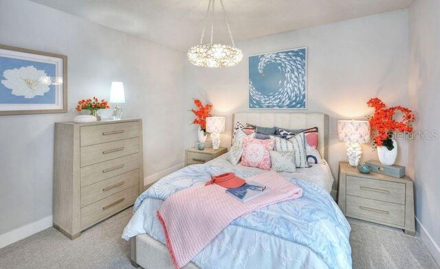 256 Stirling Bridge Dr, Ormond Beach, FL 32174 - carpeted bedroom with baseboards and a chandelier