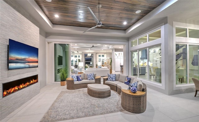 256 Stirling Bridge Dr, Ormond Beach, FL 32174 - tiled living area with ceiling fan, a fireplace, a tray ceiling, and wooden ceiling