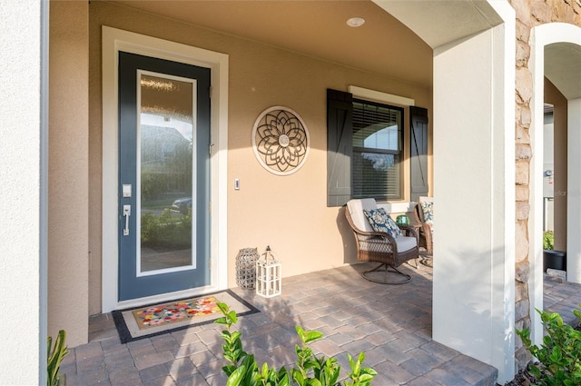 3952 Aldea Way, Wesley Chapel, FL 33543 - view of exterior entry featuring a porch and stucco siding