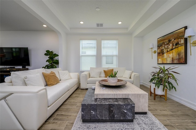 3952 Aldea Way, Wesley Chapel, FL 33543 - living room featuring wood finished floors, recessed lighting, a raised ceiling, and baseboards
