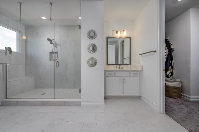3952 Aldea Way, Wesley Chapel, FL 33543 - bathroom featuring baseboards, a marble finish shower, marble look tile flooring, and vanity
