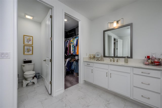 3952 Aldea Way, Wesley Chapel, FL 33543 - bathroom with marble look tile flooring, vanity, toilet, and a spacious closet