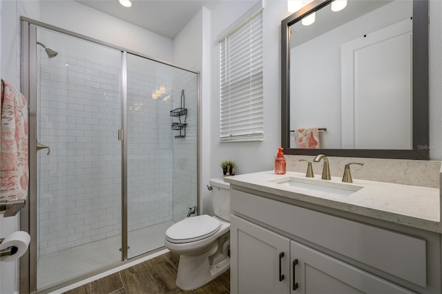 3952 Aldea Way, Wesley Chapel, FL 33543 - bathroom with wood finished floors, vanity, a stall shower, and toilet