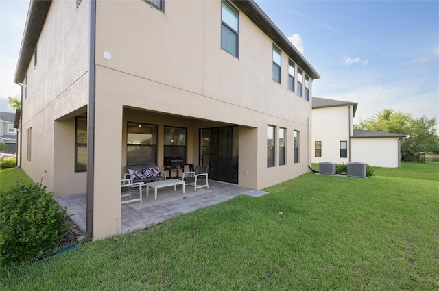 3952 Aldea Way, Wesley Chapel, FL 33543 - back of property with a patio, central air condition unit, a lawn, and stucco siding