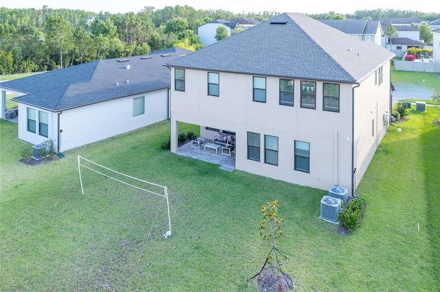 3952 Aldea Way, Wesley Chapel, FL 33543 - rear view of house with a patio, central AC, roof with shingles, and a yard