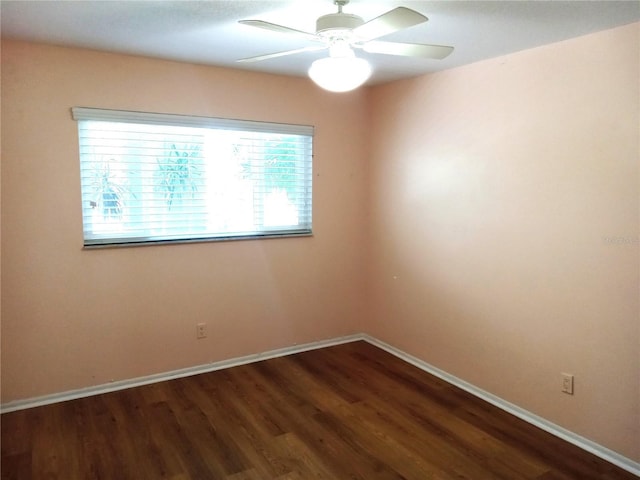 2447 Ecuadorian Way Unit 11, Clearwater, FL 33763 - unfurnished room with dark wood-style flooring, baseboards, and a ceiling fan