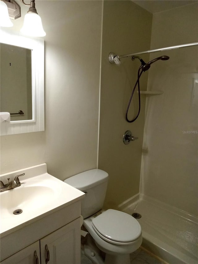 2447 Ecuadorian Way Unit 11, Clearwater, FL 33763 - bathroom featuring a stall shower, vanity, and toilet