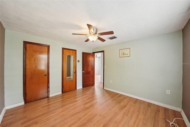 7511 N Ola Ave, Tampa, FL 33604 - unfurnished bedroom featuring light wood-type flooring, baseboards, and ceiling fan