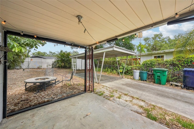 7511 N Ola Ave, Tampa, FL 33604 - fenced backyard with a fire pit, a patio, and a carport