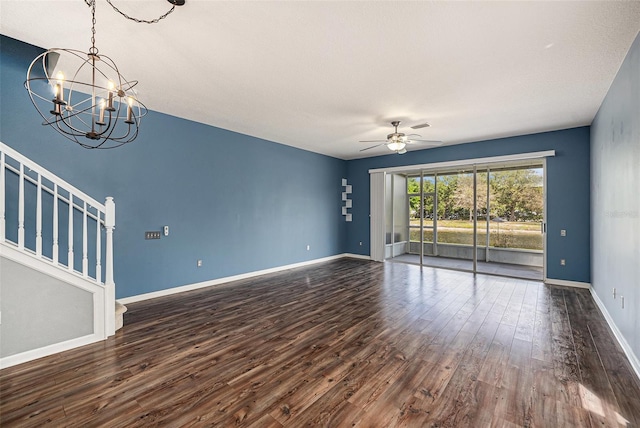 2542 Glenrise Pl, Wesley Chapel, FL 33544 - empty room featuring dark wood finished floors, ceiling fan, a chandelier, stairs, and baseboards