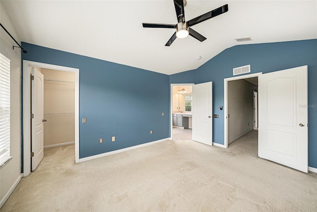 2542 Glenrise Pl, Wesley Chapel, FL 33544 - unfurnished bedroom with lofted ceiling, a walk in closet, carpet floors, baseboards, and ceiling fan
