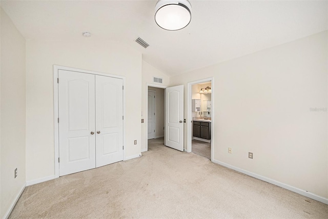 2542 Glenrise Pl, Wesley Chapel, FL 33544 - unfurnished bedroom with lofted ceiling, light colored carpet, baseboards, a closet, and ensuite bath
