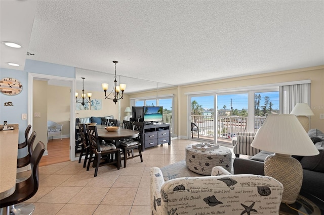 13440 Gulf Blvd Unit 202, Madeira Beach, FL 33708 - living area with a chandelier, light tile patterned floors, a textured ceiling, and baseboards