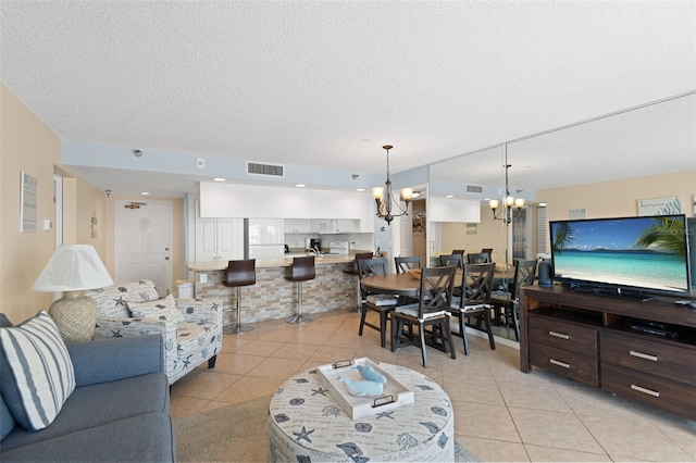 13440 Gulf Blvd Unit 202, Madeira Beach, FL 33708 - living area featuring a chandelier, light tile patterned floors, and a textured ceiling