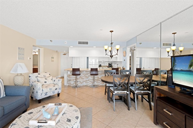 13440 Gulf Blvd Unit 202, Madeira Beach, FL 33708 - living area with a chandelier, light tile patterned floors, and a textured ceiling