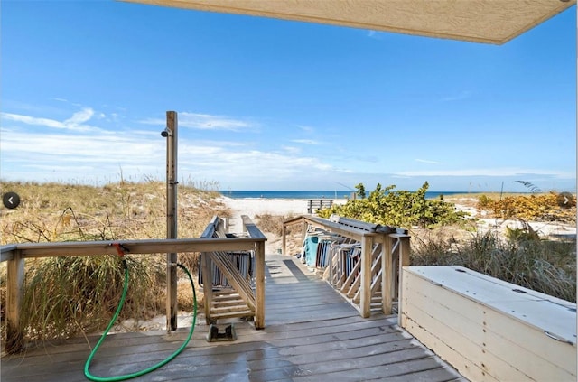 13440 Gulf Blvd Unit 202, Madeira Beach, FL 33708 - wooden deck featuring view of water and beach