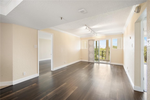 3211 W Swann Ave Unit 605, Tampa, FL 33609 - empty room featuring a textured ceiling, track lighting, crown molding, dark wood-style flooring, and baseboards