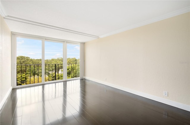 3211 W Swann Ave Unit 605, Tampa, FL 33609 - spare room featuring baseboards, dark wood-style floors, and ornamental molding