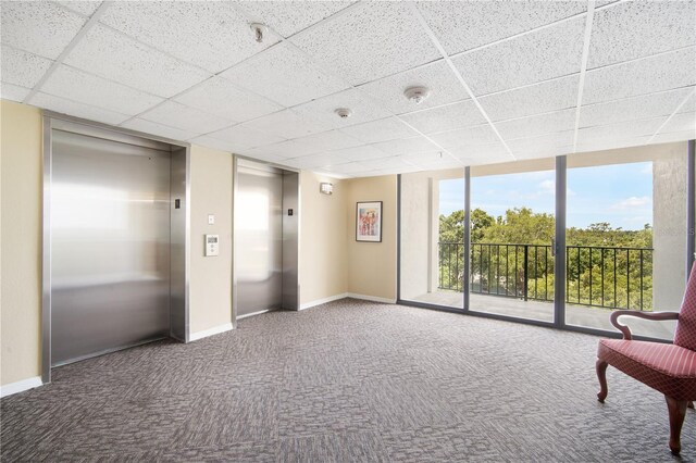 3211 W Swann Ave Unit 605, Tampa, FL 33609 - sitting room featuring elevator, carpet, a drop ceiling, baseboards, and floor to ceiling windows