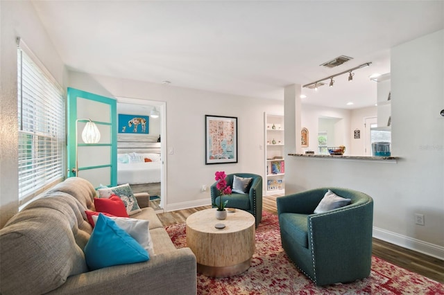 4324 S Clark Ave, Tampa, FL 33611 - living room with wood finished floors, plenty of natural light, and track lighting