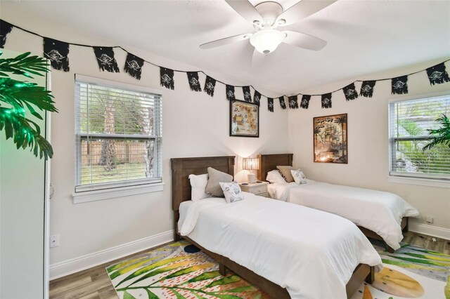 4324 S Clark Ave, Tampa, FL 33611 - bedroom with wood finished floors, baseboards, and a ceiling fan