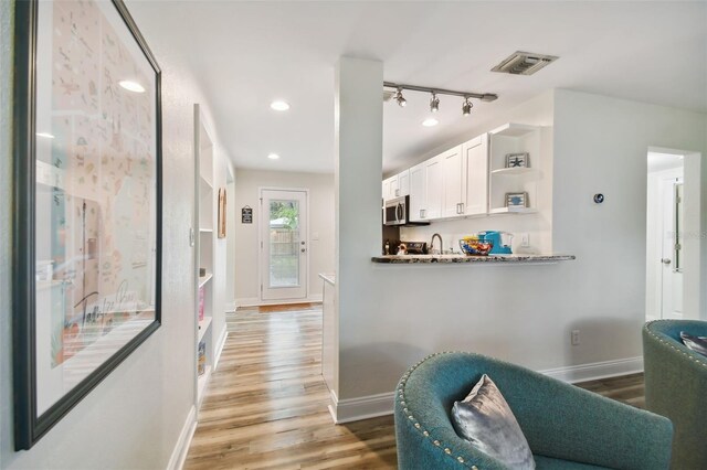 4324 S Clark Ave, Tampa, FL 33611 - kitchen featuring white cabinetry, light wood finished floors, open shelves, and baseboards