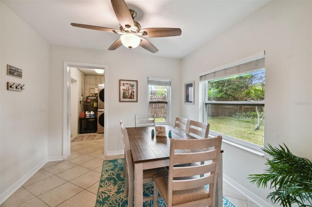 4324 S Clark Ave, Tampa, FL 33611 - dining space with stacked washing machine and dryer, ceiling fan, light tile patterned floors, and baseboards