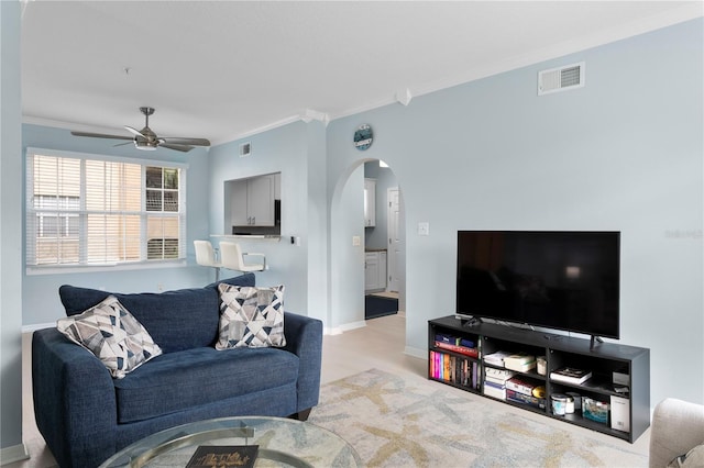 501 Knights Run Ave Unit 5103, Tampa, FL 33602 - living area with arched walkways, ornamental molding, ceiling fan, and baseboards