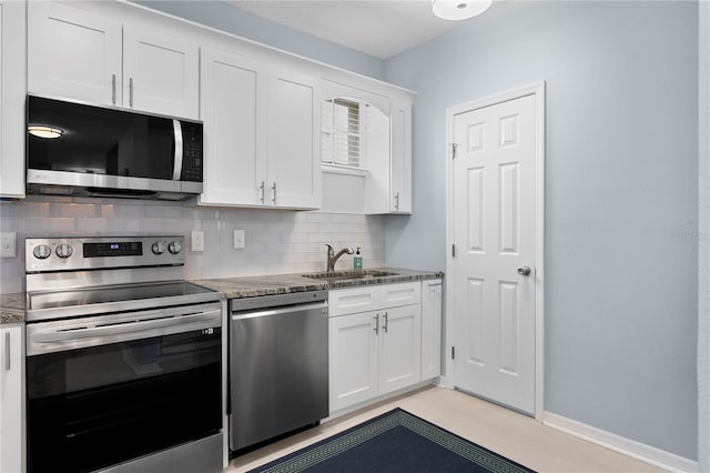 501 Knights Run Ave Unit 5103, Tampa, FL 33602 - kitchen featuring stainless steel appliances, a sink, decorative backsplash, white cabinets, and stone countertops